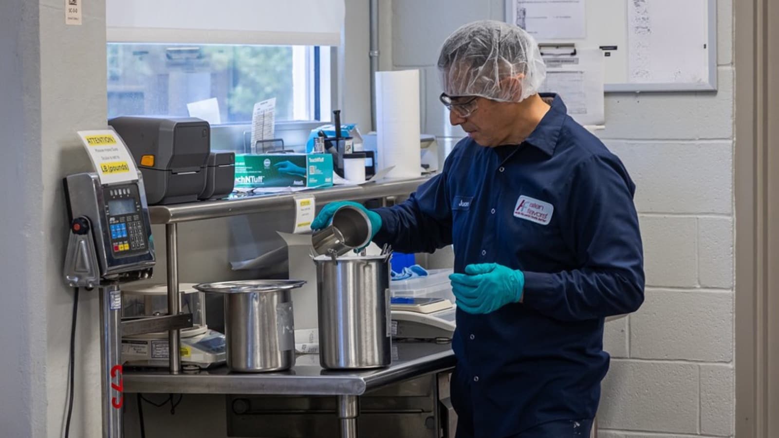 Technician weighing components at the small flavor compounding bench